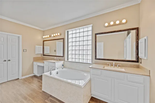 a bathroom with a tub sink and mirror