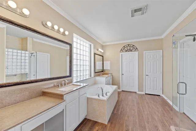 a spacious bathroom with a bathtub sink and mirror