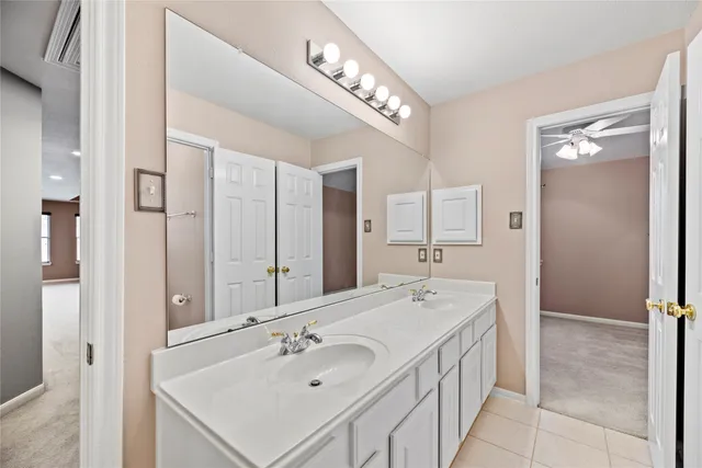 a bathroom with a sink double vanity and a mirror