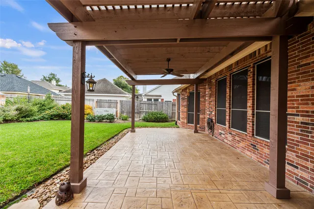 a view of a porch with wooden floor and garden