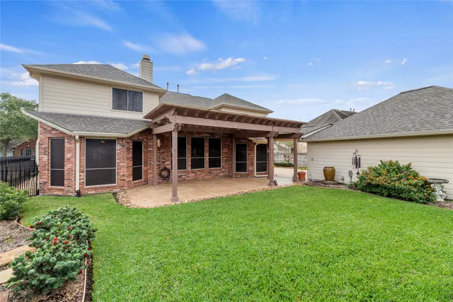 a view of a house with a yard and sitting area