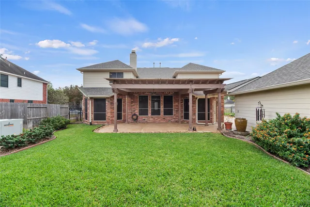 a front view of a house with swimming pool garden and patio