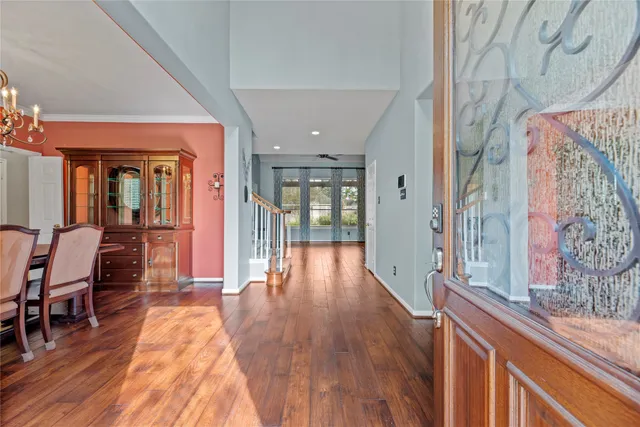a view of a hallway with wooden floor and furniture