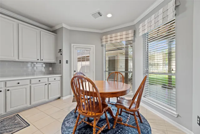 a view of a dining room with furniture and windows