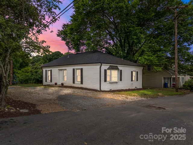 a big house with a big yard and large trees