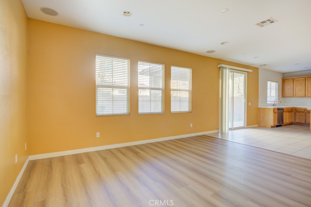 4587 Vincent Way Riverside, CA 92501 - Photo 14 of 51 a view of an empty room with wooden floor and a window