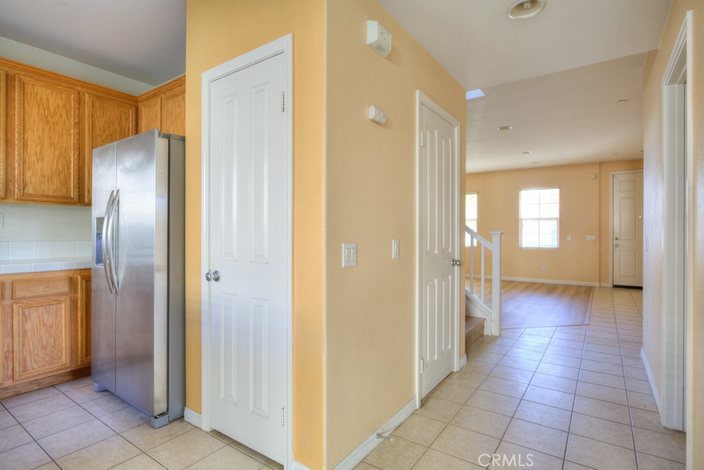 4587 Vincent Way Riverside, CA 92501 - Photo 16 of 51 a view of a hallway with wooden shelves
