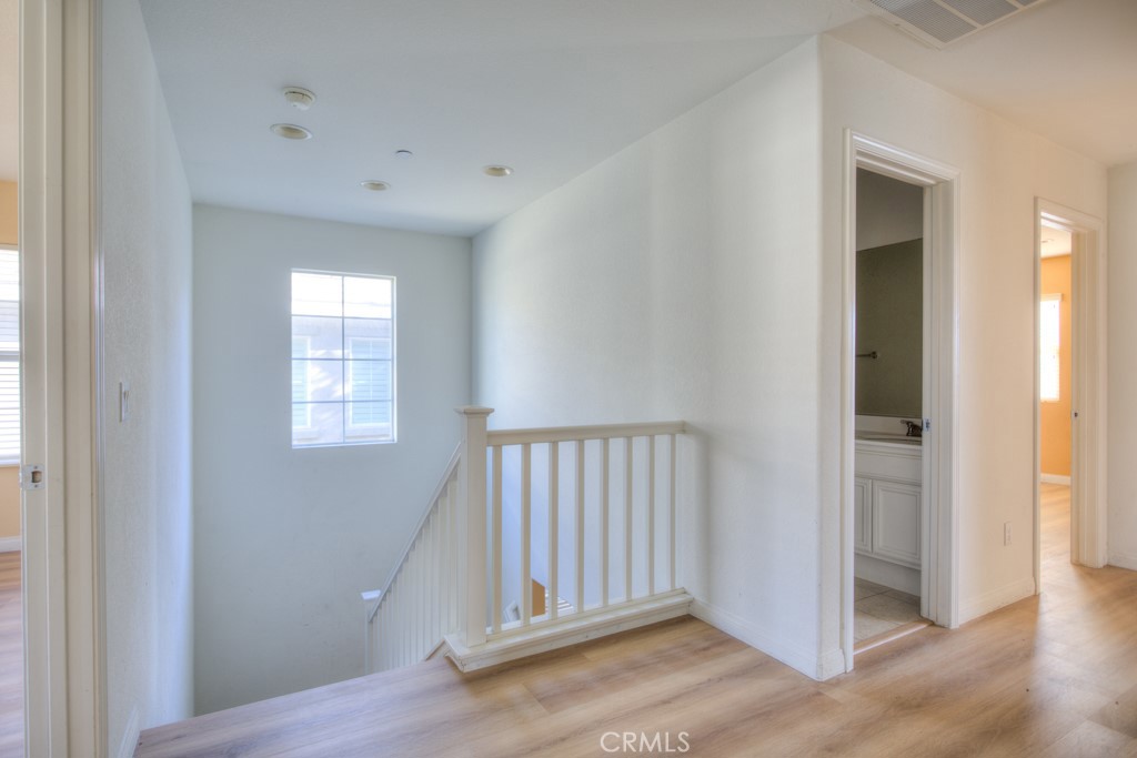 4587 Vincent Way Riverside, CA 92501 - Photo 19 of 51 an empty room with wooden floor and windows