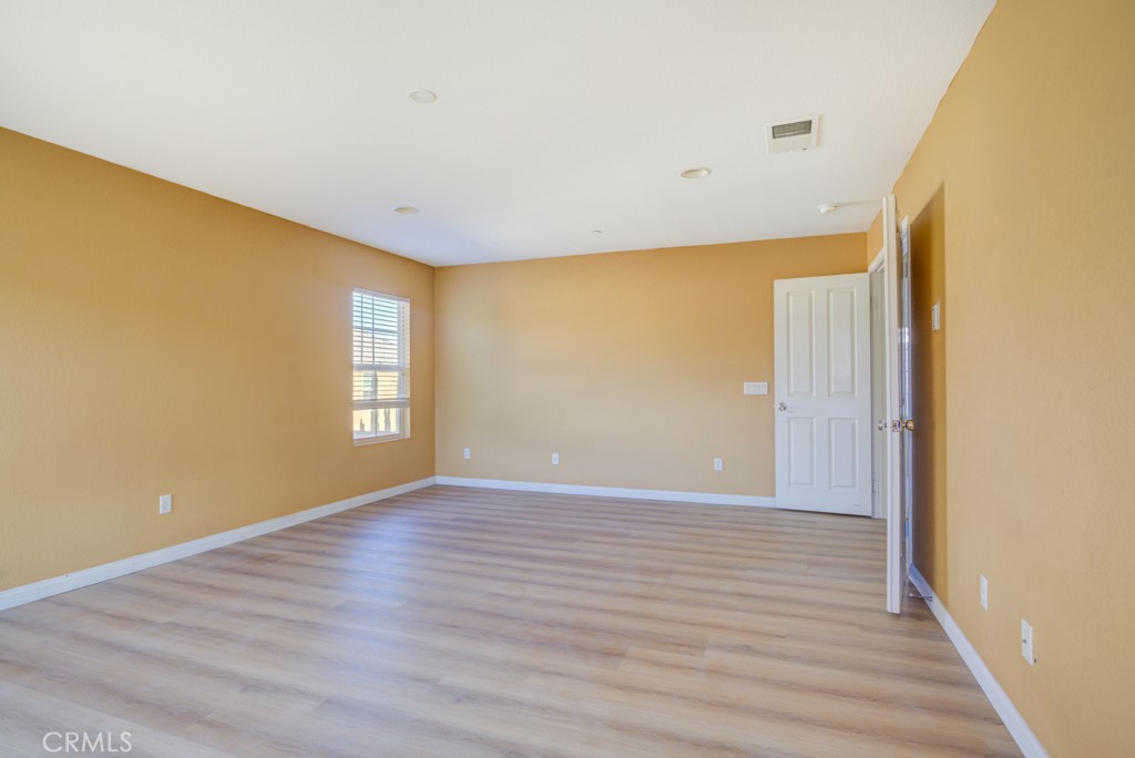 4587 Vincent Way Riverside, CA 92501 - Photo 24 of 51 a view of an empty room with wooden floor and a window