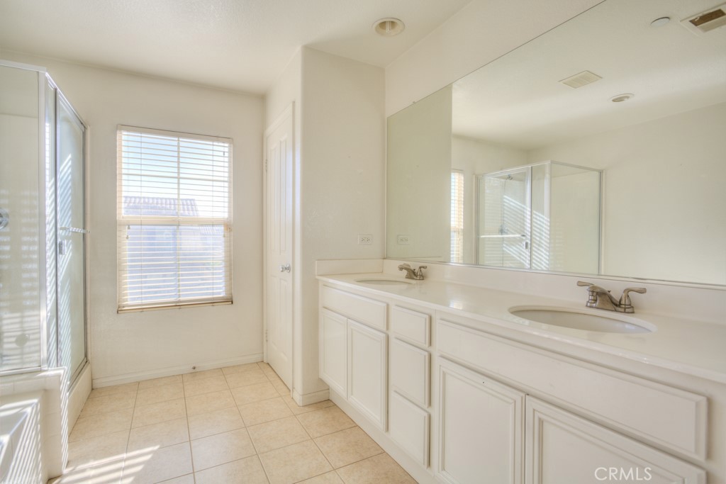 4587 Vincent Way Riverside, CA 92501 - Photo 27 of 51 a bathroom with a sink a toilet and a mirror