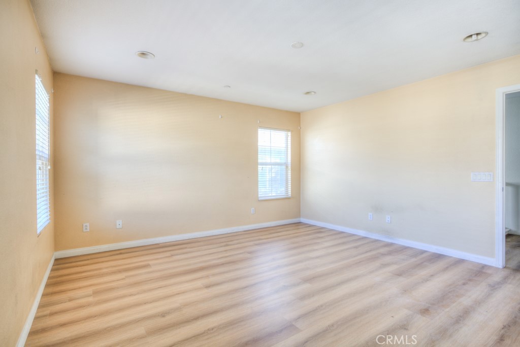 4587 Vincent Way Riverside, CA 92501 - Photo 33 of 51 a view of an empty room with wooden floor and a window