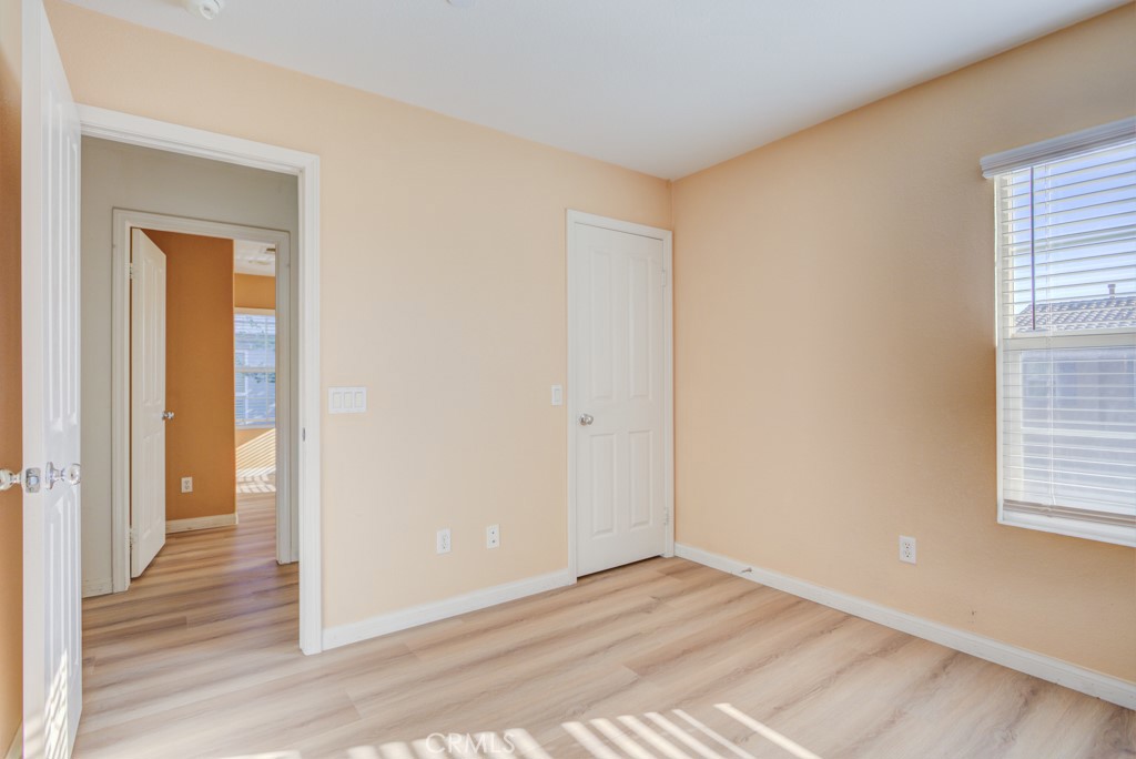 4587 Vincent Way Riverside, CA 92501 - Photo 36 of 51 a view of an empty room with wooden floor and a window