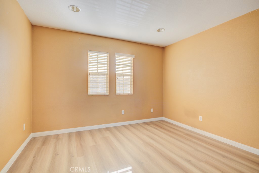 4587 Vincent Way Riverside, CA 92501 - Photo 40 of 51 a view of an empty room with wooden floor and a window