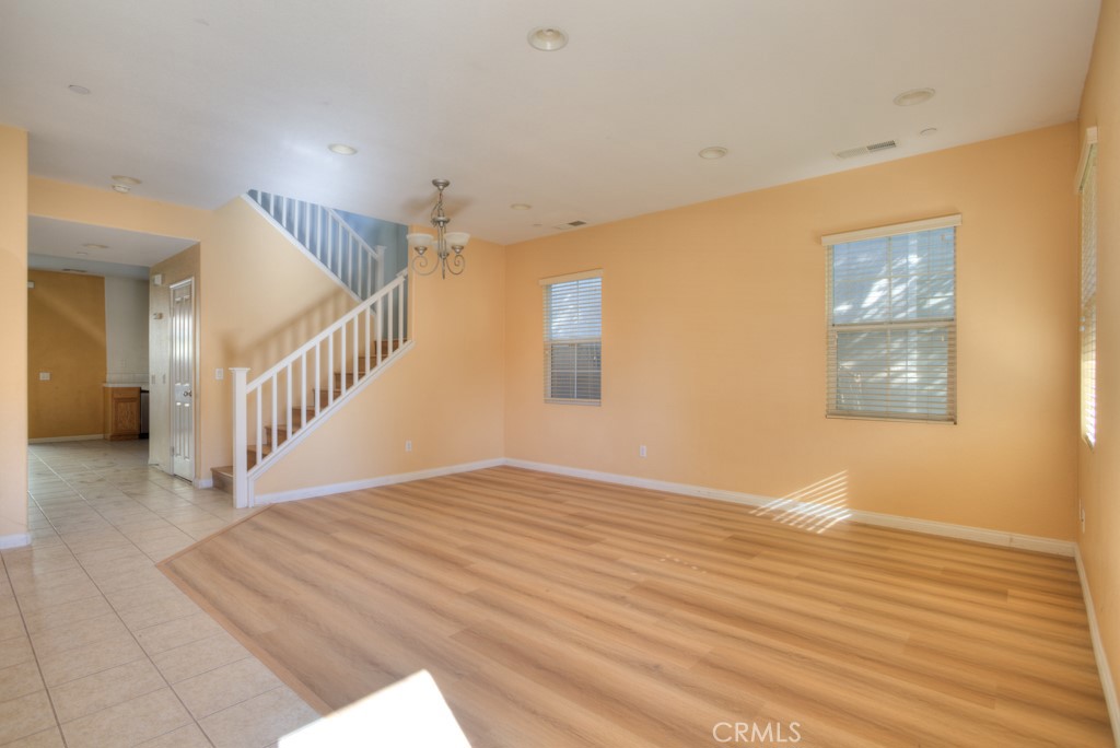 4587 Vincent Way Riverside, CA 92501 - Photo 4 of 51 a view of an empty room with wooden floor and a window