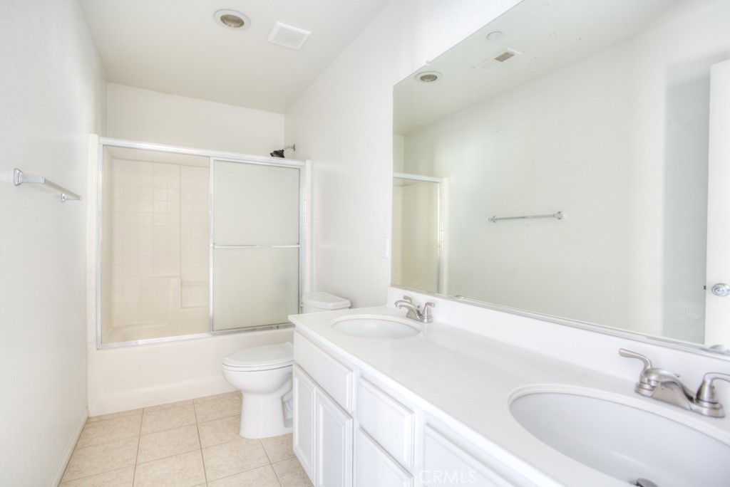 4587 Vincent Way Riverside, CA 92501 - Photo 42 of 51 a bathroom with a sink a toilet and shower