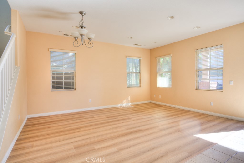 4587 Vincent Way Riverside, CA 92501 - Photo 7 of 51 a view of empty room with wooden floor and fan