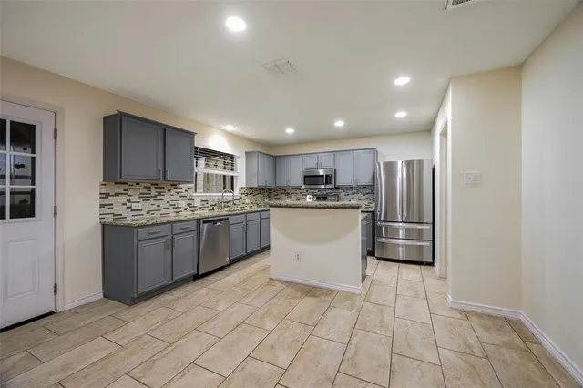 a kitchen with stainless steel appliances a refrigerator sink and cabinets