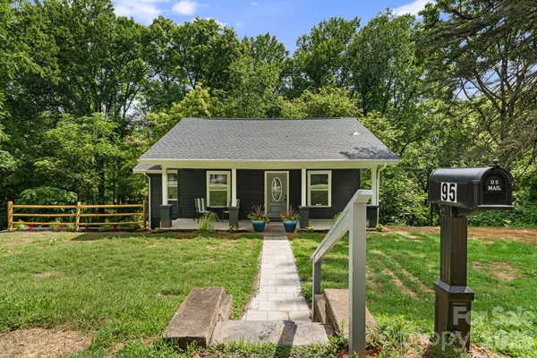 a view of house with outdoor space and garden