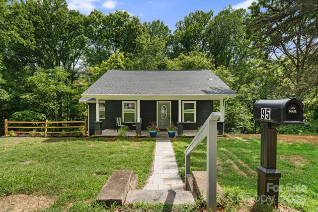 a view of house with outdoor space and garden