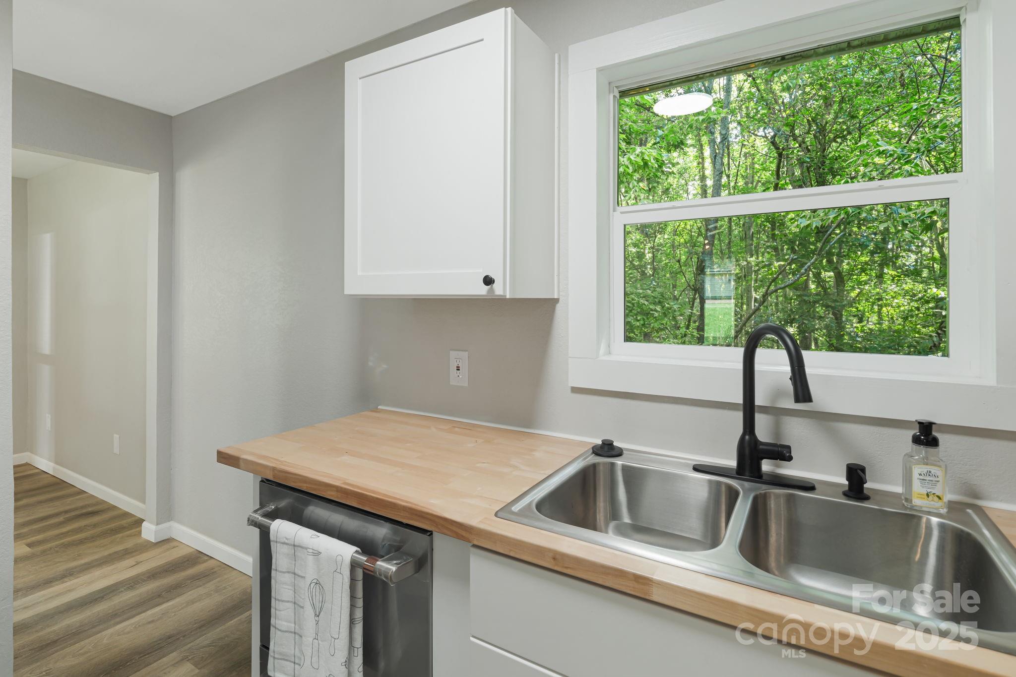 95 Grassy View Road Candler, NC 28715 - Photo 11 of 27 a kitchen with a sink and a window