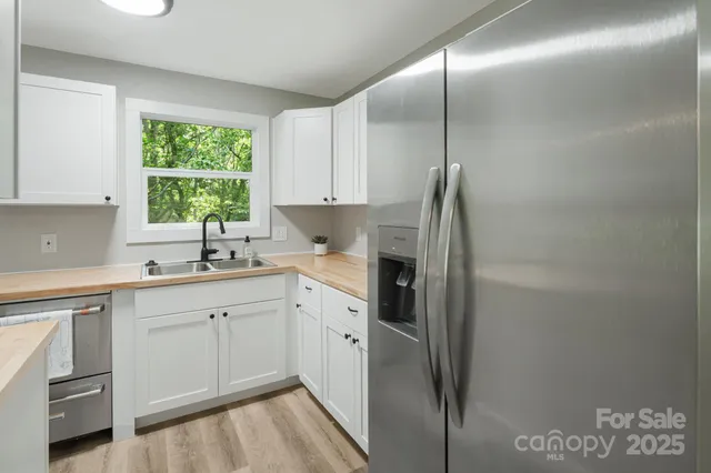 a kitchen with white cabinets and white appliances