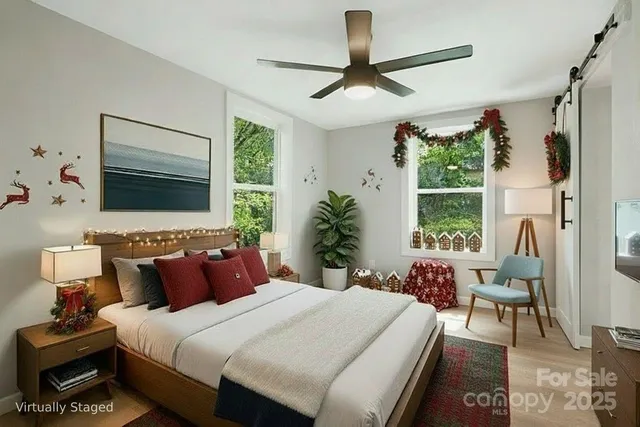 a bedroom with a bed a chandelier and a large window