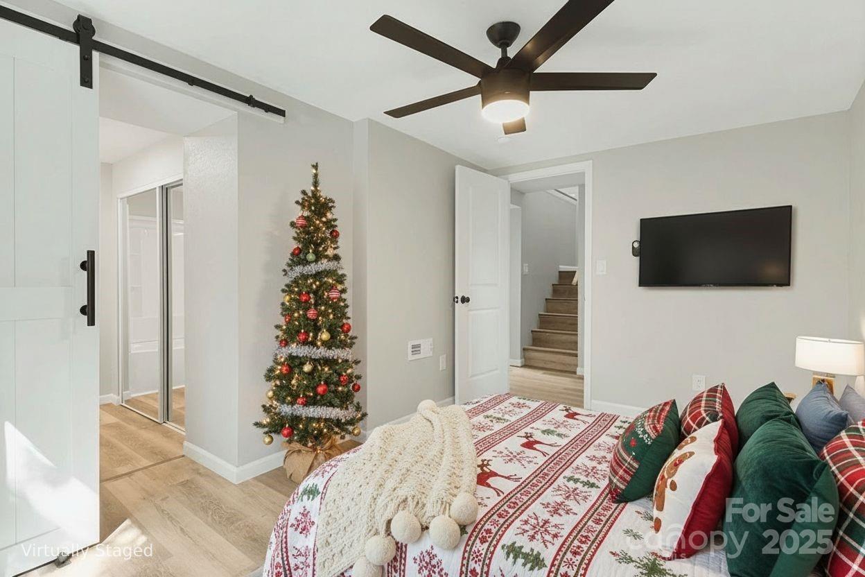 95 Grassy View Road Candler, NC 28715 - Photo 19 of 27 a bedroom with a bed and a flat screen tv