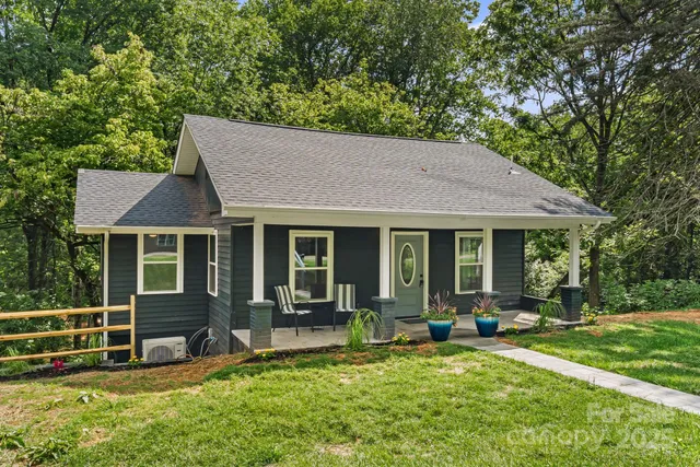 a view of a house with backyard porch and sitting area