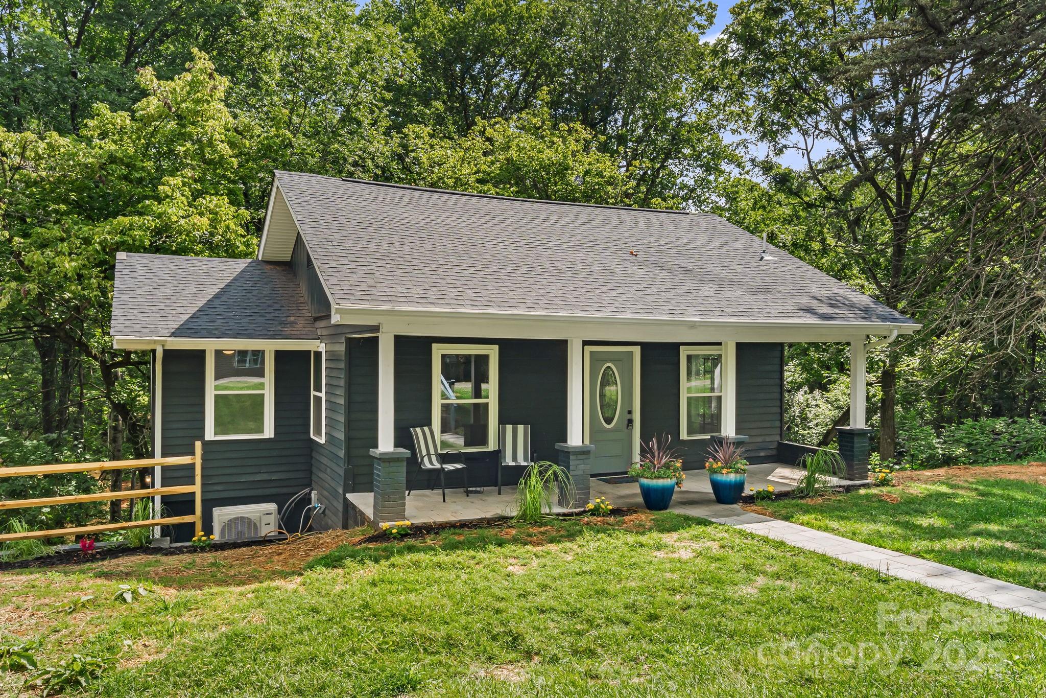95 Grassy View Road Candler, NC 28715 - Photo 2 of 27 a view of a house with backyard porch and sitting area