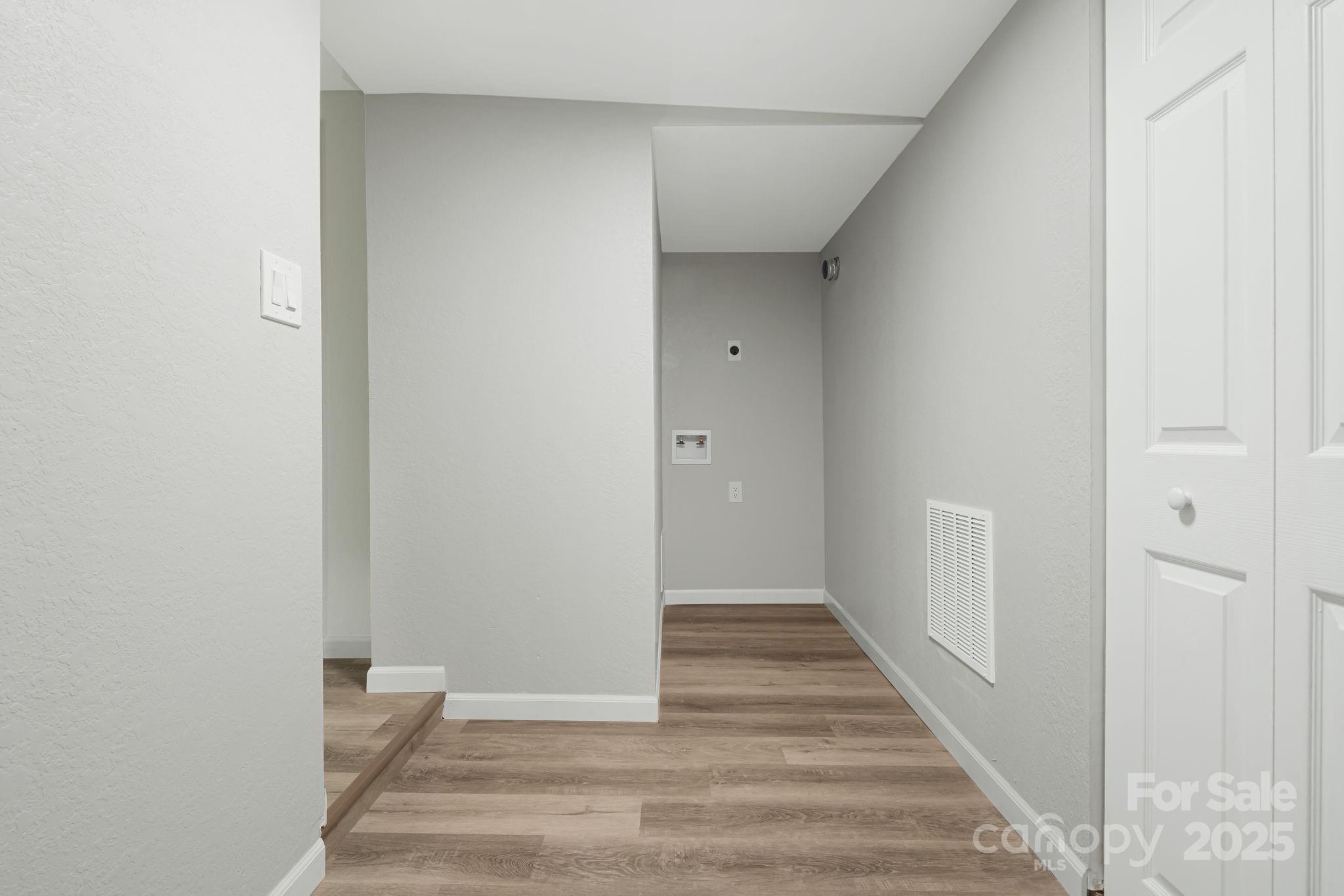 95 Grassy View Road Candler, NC 28715 - Photo 21 of 27 a view of a hallway with wooden floor and entryway