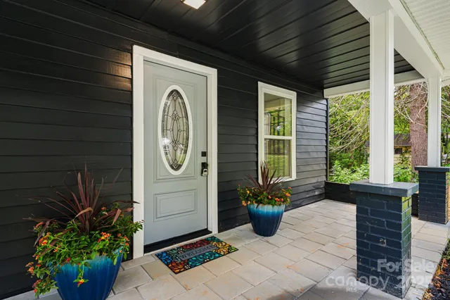 a front view of a house with outdoor seating