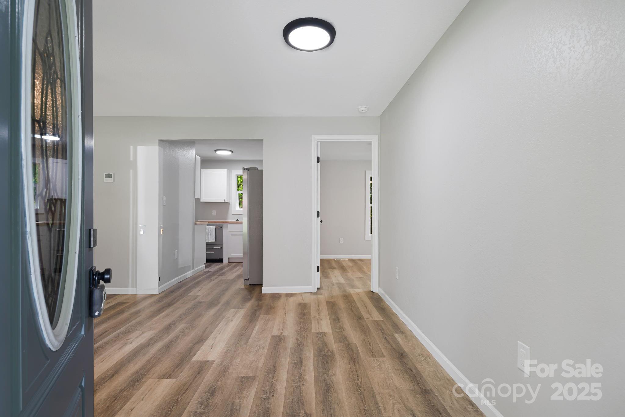 95 Grassy View Road Candler, NC 28715 - Photo 5 of 27 a view of a room with wooden floor and a bathroom