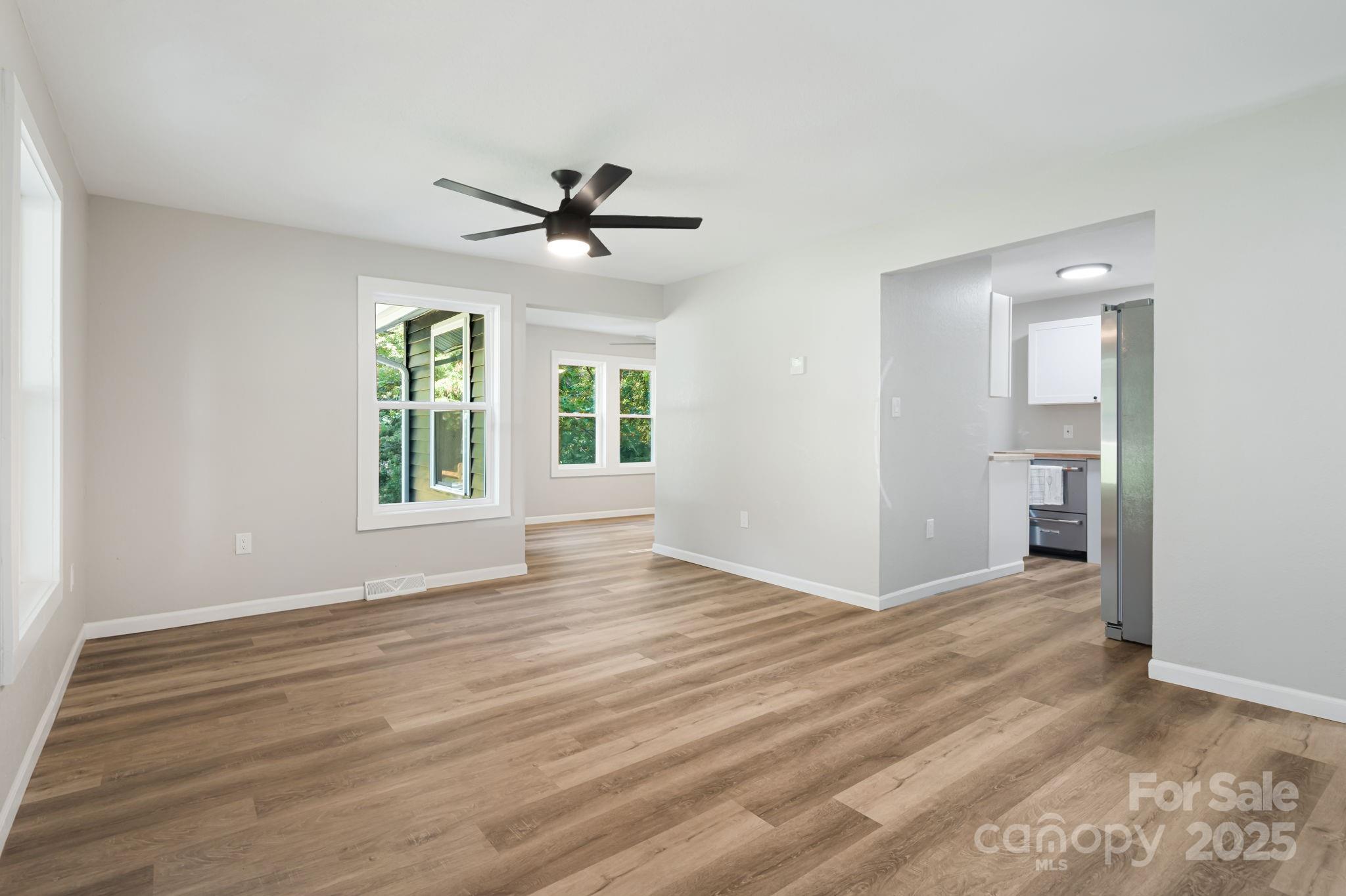 95 Grassy View Road Candler, NC 28715 - Photo 6 of 27 a view of an empty room with a window and wooden floor