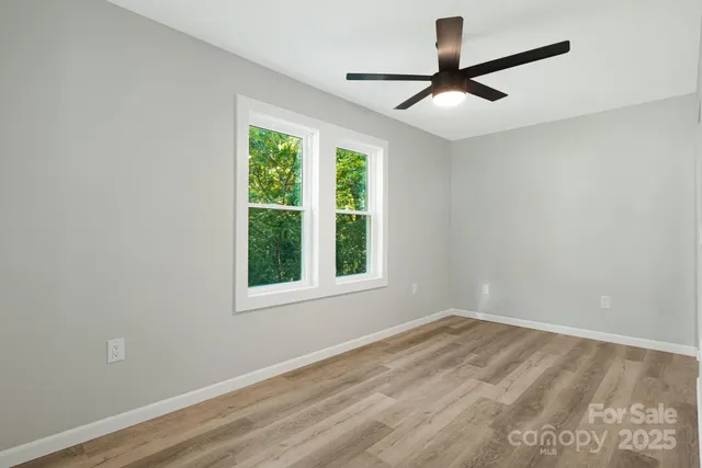 a view of empty room with ceiling fan