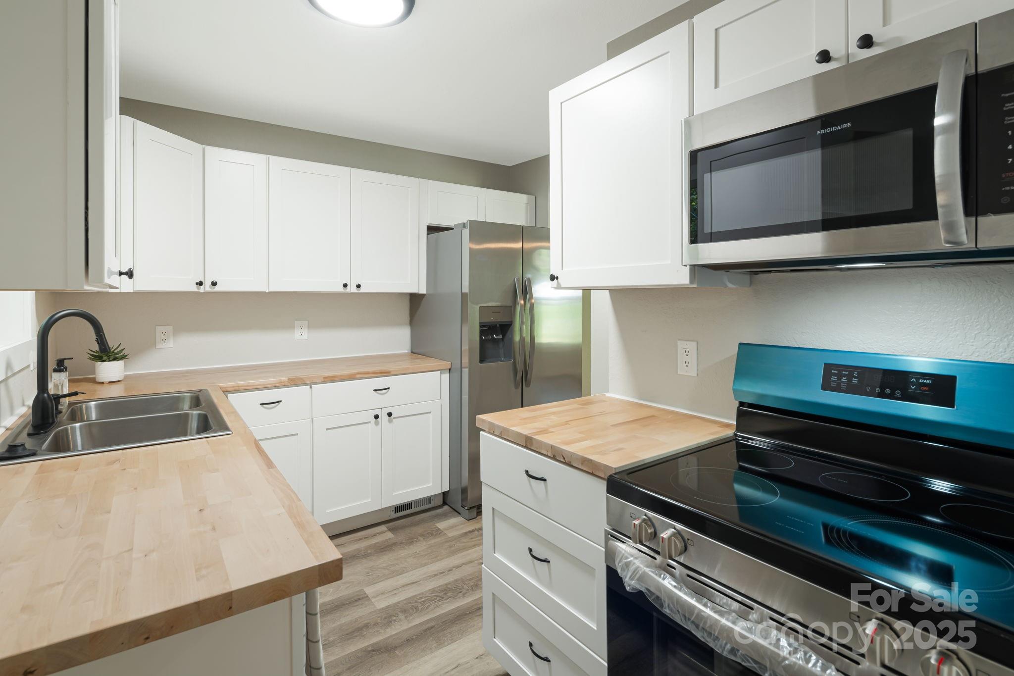 95 Grassy View Road Candler, NC 28715 - Photo 10 of 27 a kitchen with appliances a sink and cabinets