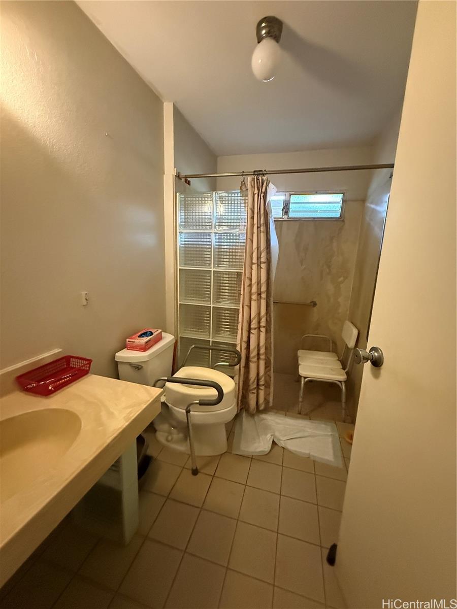 94-571 Ana Aina Place Waipahu, HI 96797 - Photo 11 of 16 a bathroom with a sink toilet and shower