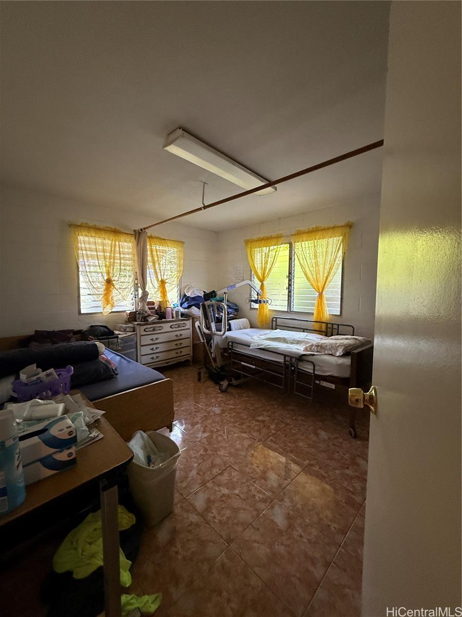 94-571 Ana Aina Place Waipahu, HI 96797 - Photo 12 of 16 a living room with furniture and a large window