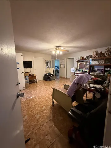 a gym room with lots of furniture and clutter