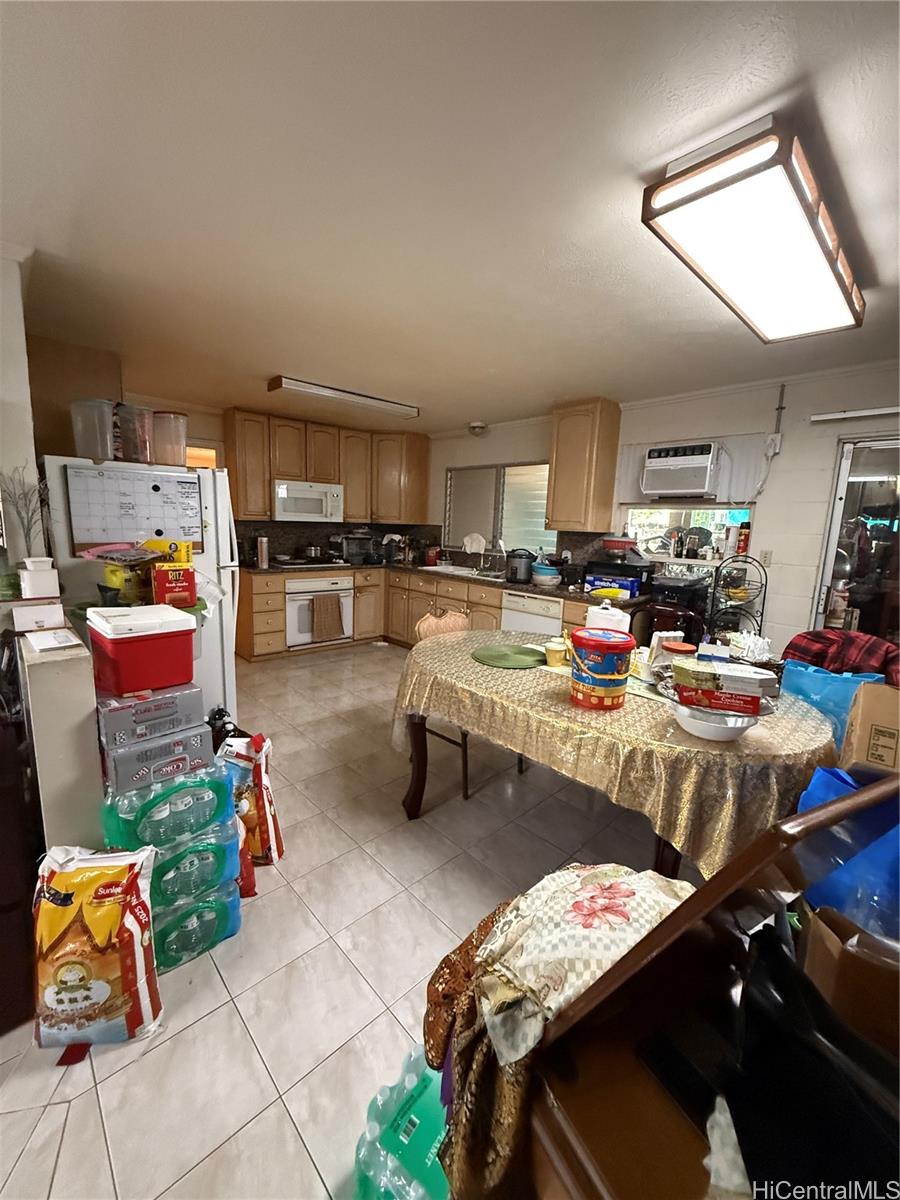 94-571 Ana Aina Place Waipahu, HI 96797 - Photo 15 of 16 a gym room with lots of furniture and clutter