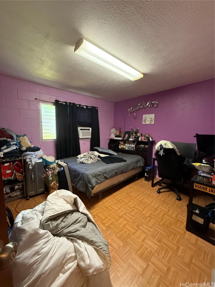 94-571 Ana Aina Place Waipahu, HI 96797 - Photo 3 of 16 a bedroom with two beds and a computer on the desk