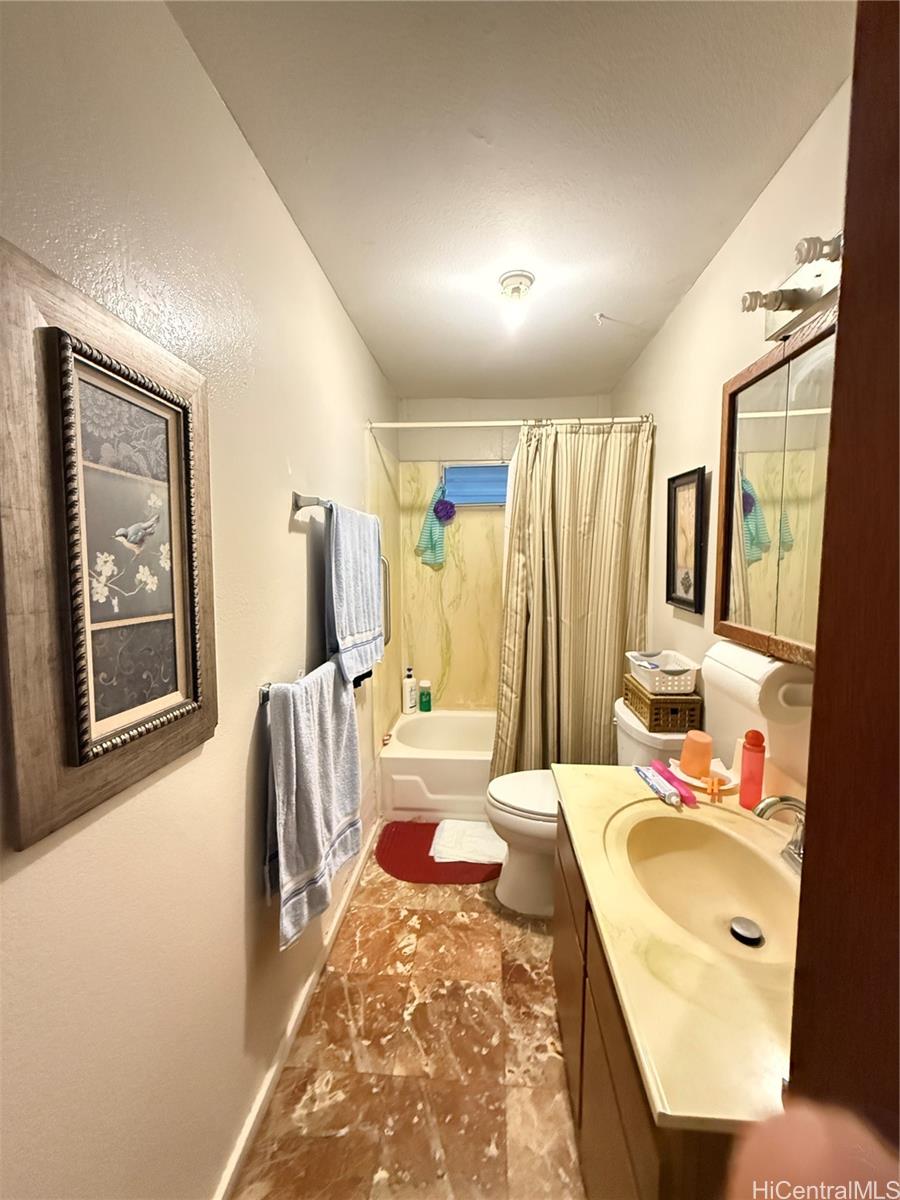 94-571 Ana Aina Place Waipahu, HI 96797 - Photo 6 of 16 a bathroom with a tub sink and mirror