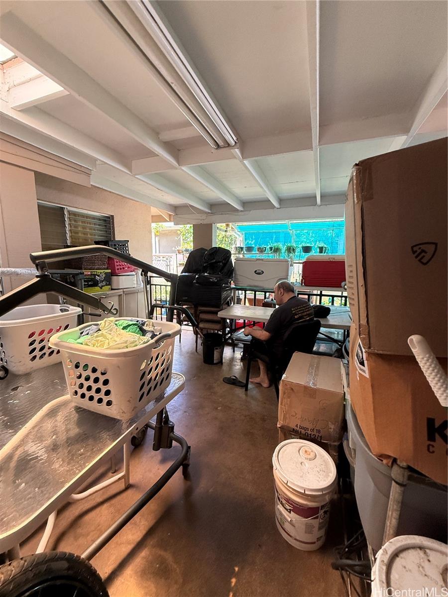 94-571 Ana Aina Place Waipahu, HI 96797 - Photo 7 of 16 a room with furniture a flat screen tv and a large window