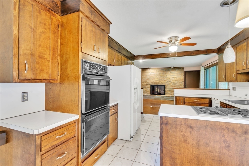 11 Brooks Road Longmeadow, MA 01106 - Photo 12 of 27 a kitchen with stainless steel appliances granite countertop a refrigerator a stove and a sink with wooden floor