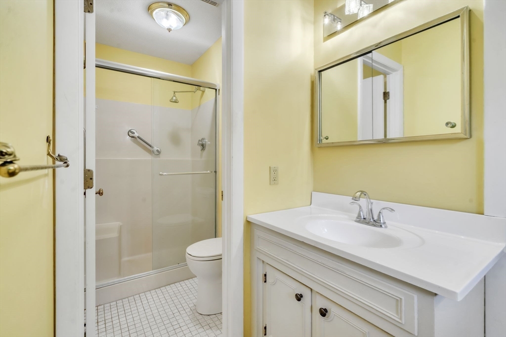 11 Brooks Road Longmeadow, MA 01106 - Photo 23 of 27 a bathroom with a sink a toilet and shower