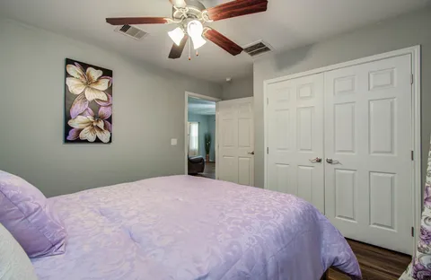 a bedroom with a large bed and a chandelier