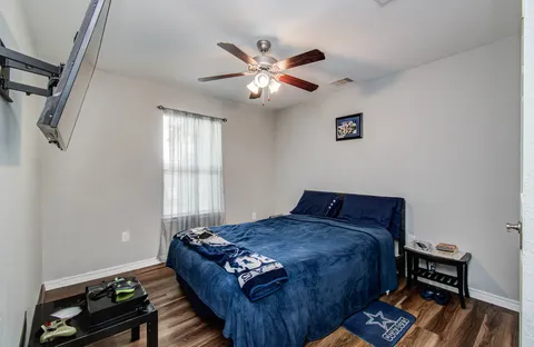 a bed sitting in a bedroom next to a window
