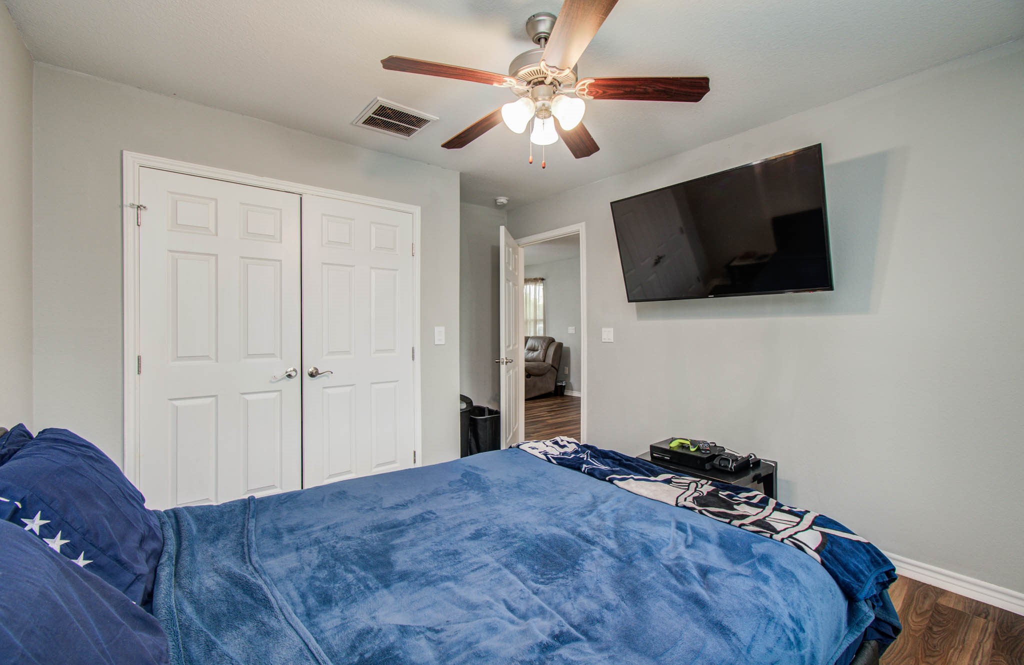 2722 Vega Houston, TX 77088 - Photo 18 of 45 a bedroom with a bed and a flat screen tv