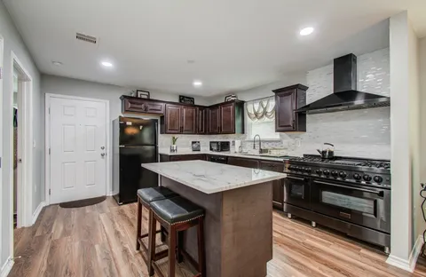 a kitchen with a stove a refrigerator and a sink