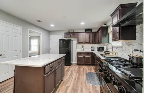a kitchen with a stove sink and refrigerator