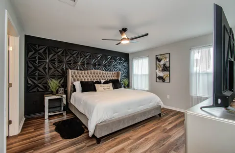 a bedroom with a bed and a chandelier